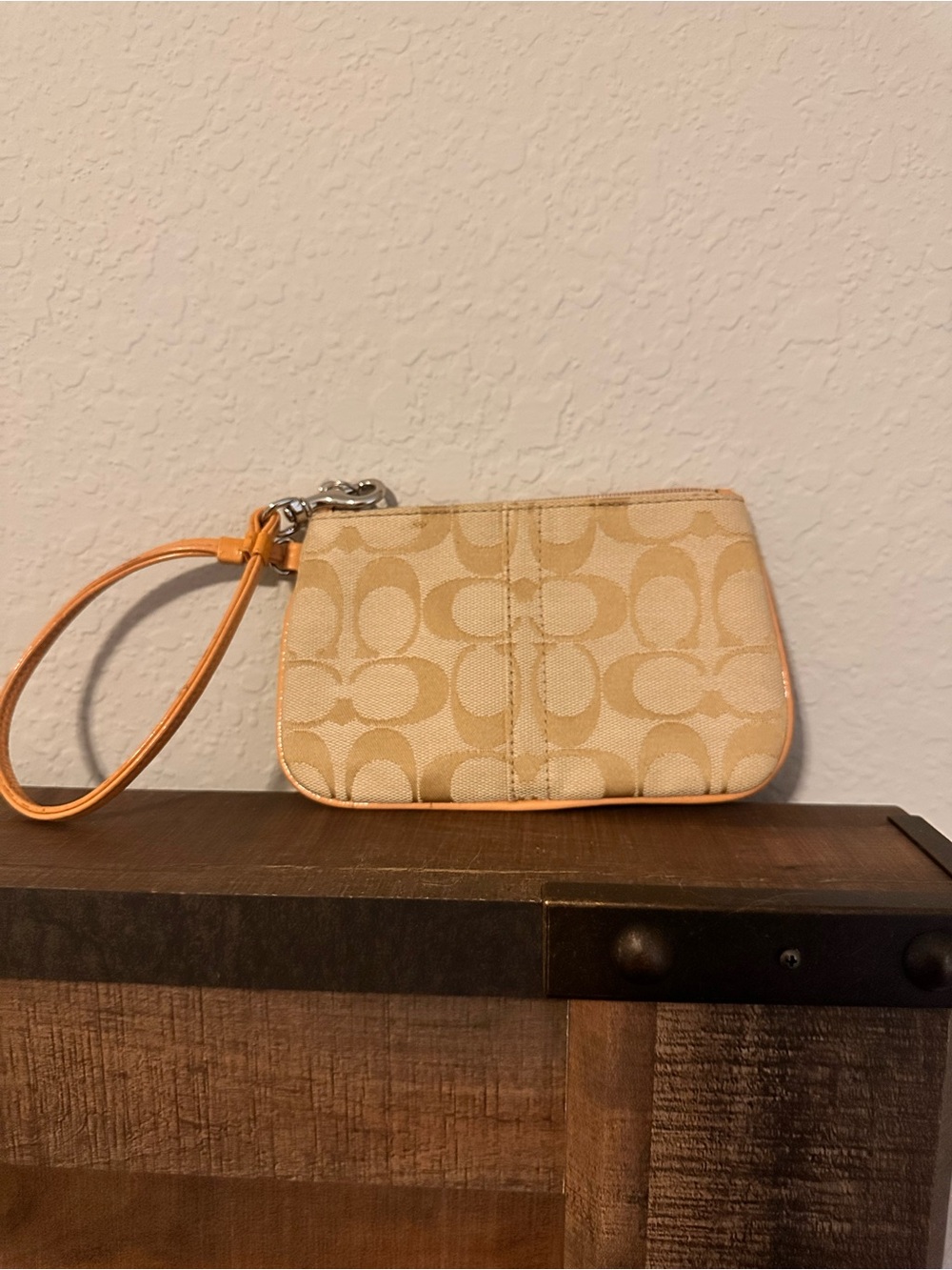Coach Beige Signature Canvas Wristlet with a salmon colored Trim